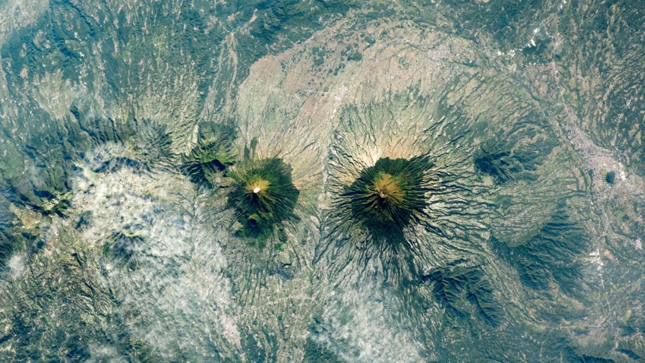 Indonesia's Twin Volcanoes Form Striking Mirror Image