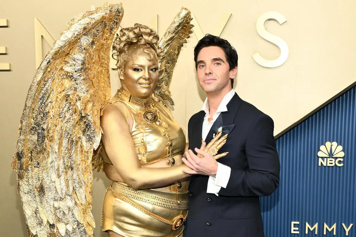 Meg Stalter Turns Heads as Golden Emmy Statue on Red Carpet